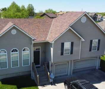 Cedar shingle roof installed on grey home in Kansas City, MO